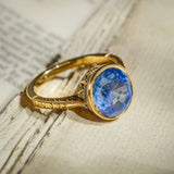 Cornflower blue Ceylon sapphire solitaire ring with round blue gemstone in gold setting