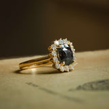 Cushion cut green sapphire with diamond cluster halo engagement ring in yellow gold