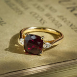 Cushion cut 3ct ruby and diamond three stone engagement ring in yellow gold
