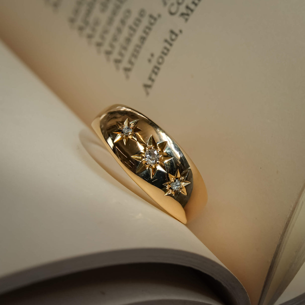 Edwardian gypsy ring with three star set diamonds in gold band