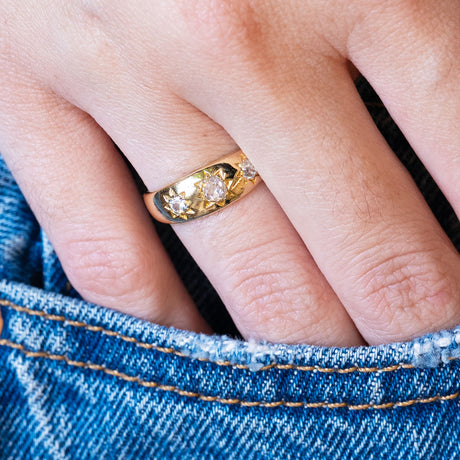 Antique Edwardian old-mine cut diamond gypsy ring styled with denim pocket.