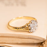 Edwardian diamond cluster ring with sparkling old-cut diamonds forming a classic daisy motif in a refined yellow and white gold setting.