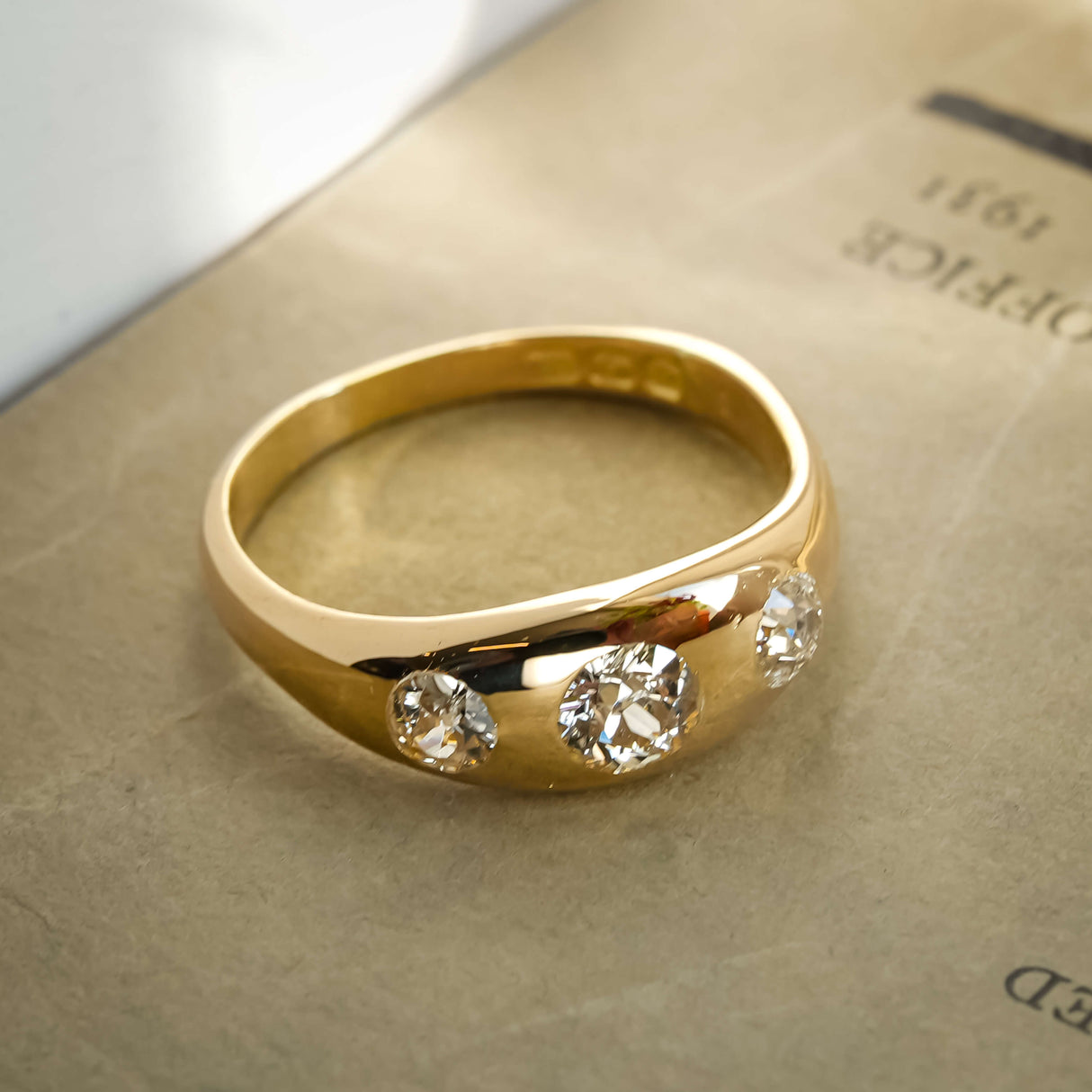 edwardian old cut diamond gypsy three stone ring with antique design in yellow gold
