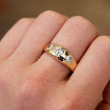 Gold gypsy ring with three old cut diamonds showing soft sparkle and smooth curved surface.
