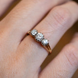 Three stone diamond ring showing old cut stones with soft sparkle.
