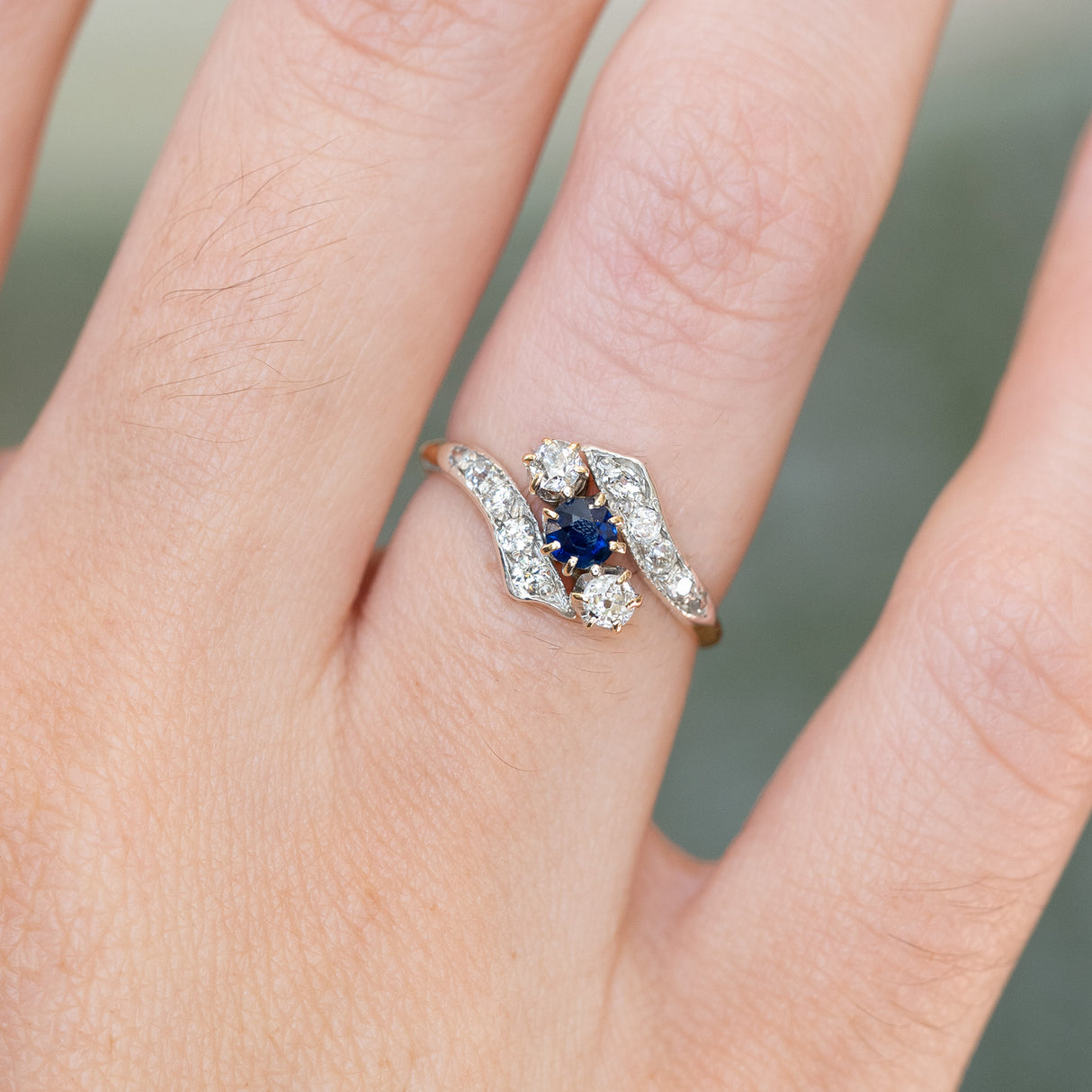 Edwardian sapphire and diamond twist ring with curved band detail