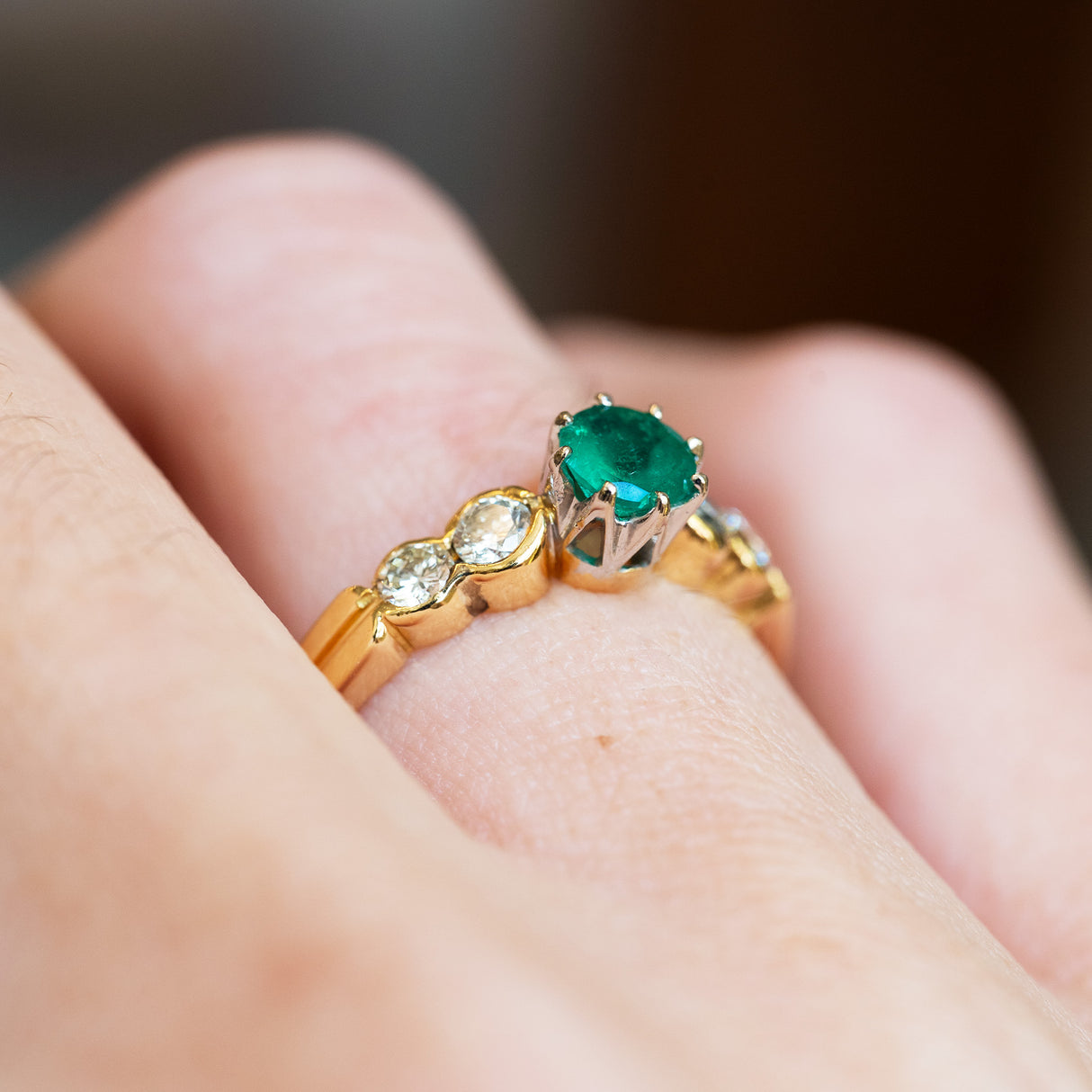 Emerald five stone ring detail highlighting setting and diamond spacing.