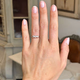 Antique Edwardian yellow gold three-stone ring worn on hand, showcasing old-cut brown, pink and champagne coloured diamonds in an elegant and timeless design.