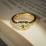 Fancy light yellow diamond ring with trefoil cluster design and white diamond accents