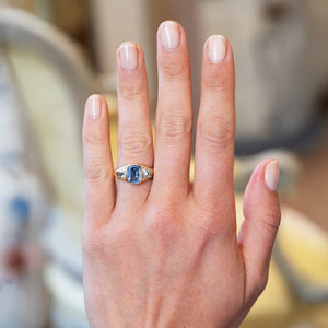 Georgian sapphire and diamond three stone ring worn on hand.