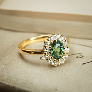 Green sapphire and diamond cluster engagement ring in yellow gold