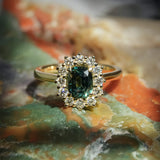 Green sapphire cluster ring with diamonds set in yellow gold band