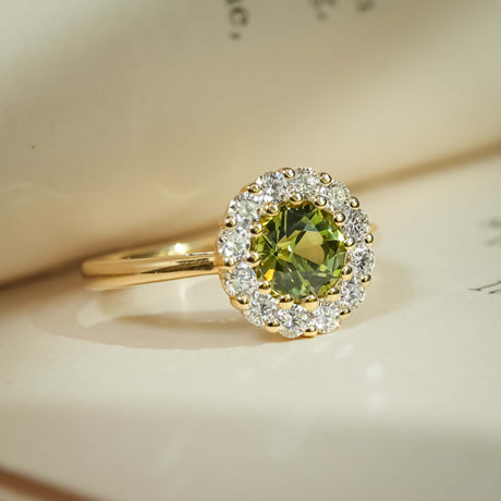 Green sapphire cluster ring with diamond surround on gold band