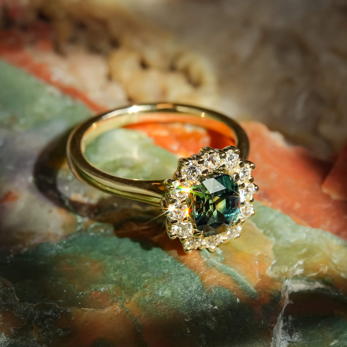 Green sapphire and diamond cluster engagement ring with oval gemstone