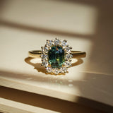 Green sapphire and diamond engagement ring with cluster setting