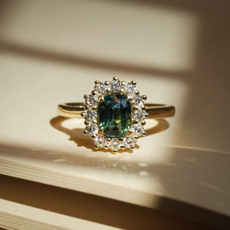 Green sapphire and diamond engagement ring with cluster setting