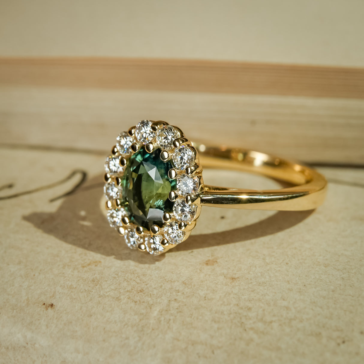 Green sapphire diamond halo engagement ring set in yellow gold band