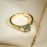 Green sapphire and diamond three stone engagement ring in gold setting