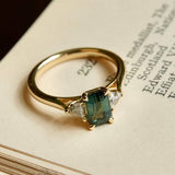 Green sapphire and diamond three stone engagement ring in yellow gold