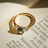 Green sapphire center stone with trillion diamonds three stone engagement ring
