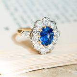 Vintage 1960s French sapphire and diamond cluster ring with oval sapphire centre surrounded by round brilliant diamonds.