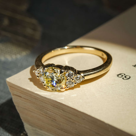 Light yellow diamond ring with trefoil cluster and white diamond accents