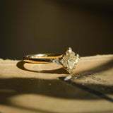 Marquise diamond with side diamonds three stone engagement ring in yellow gold