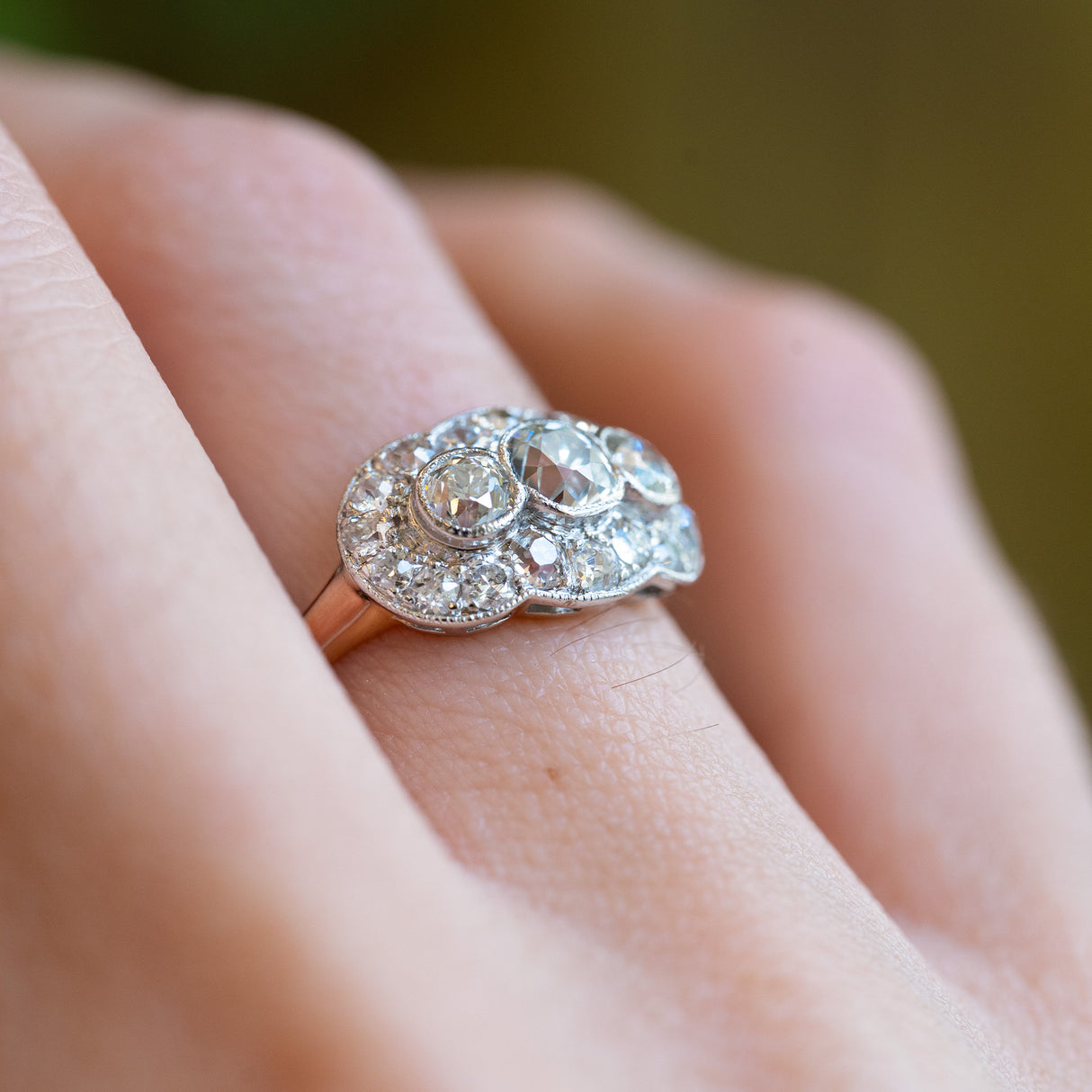 Diamond cluster ring detail highlighting old cut stones and intricate setting.
