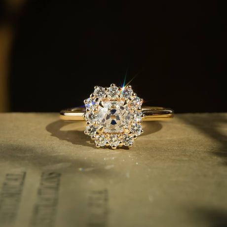 old mine cushion diamond cluster engagement ring in yellow gold with halo setting
