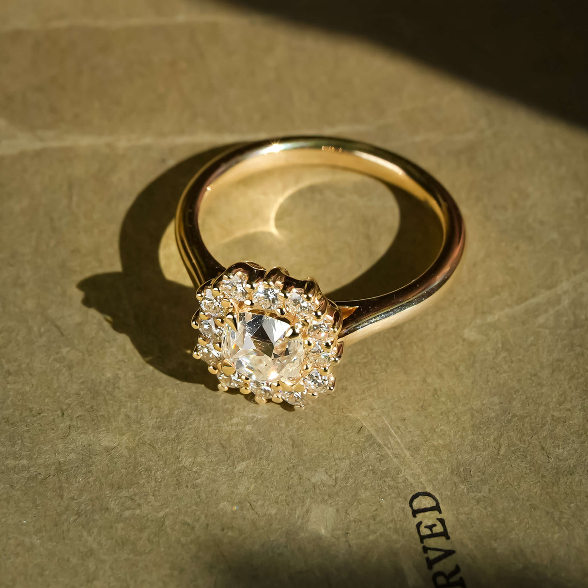 old mine cushion diamond halo cluster ring with round accent diamonds in yellow gold