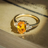 Cushion cut orange sapphire ring with diamond cluster trefoil setting