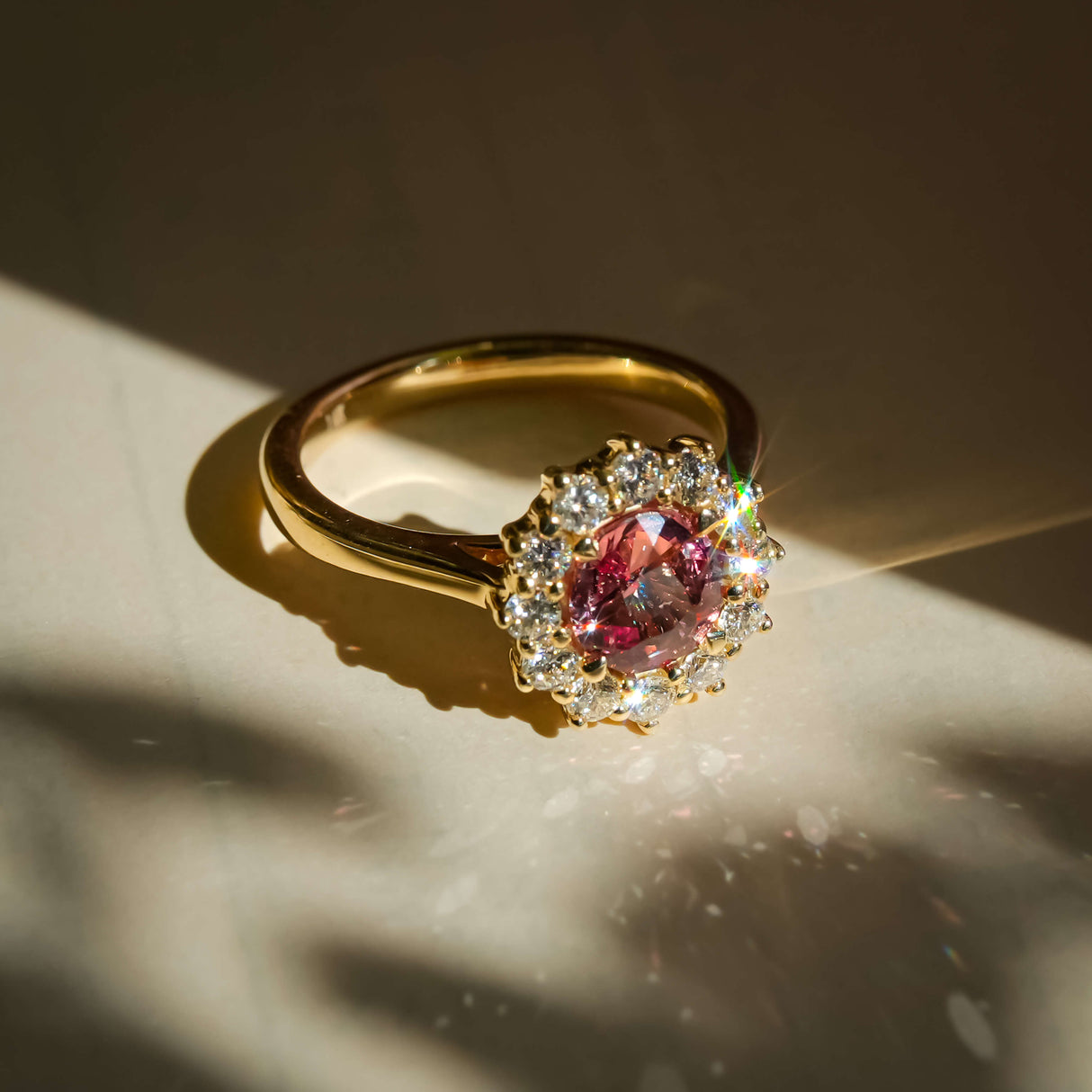 orange sapphire diamond halo cluster ring with round accent diamonds in yellow gold