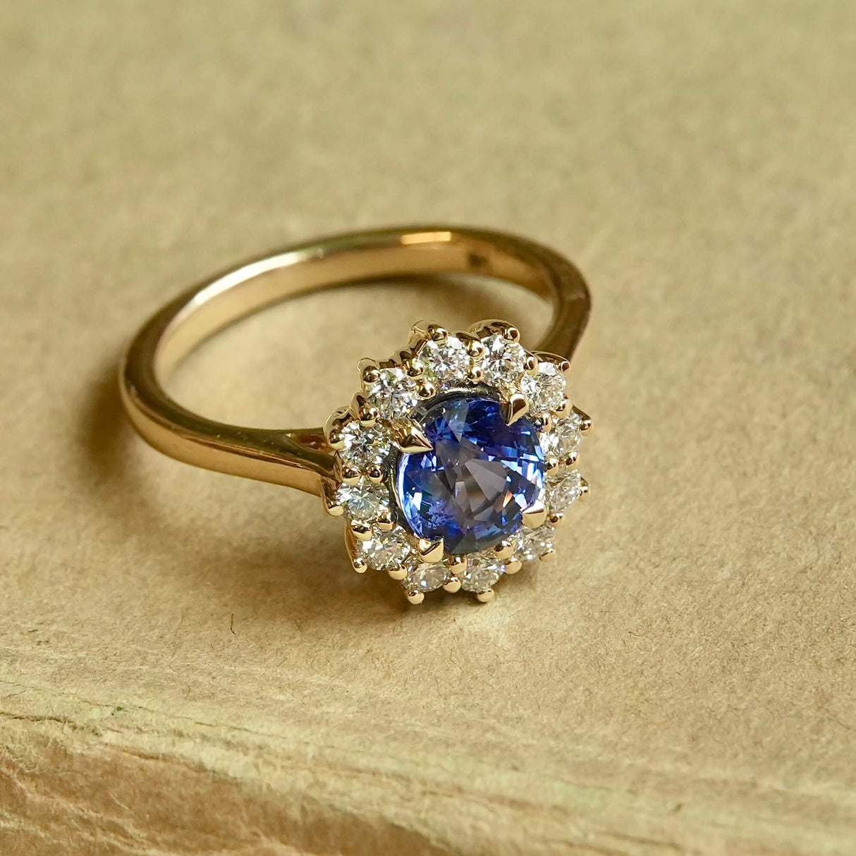 Oval-cut blue sapphire and diamond cluster engagement ring