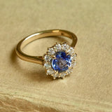 Oval-cut blue sapphire and diamond cluster engagement ring