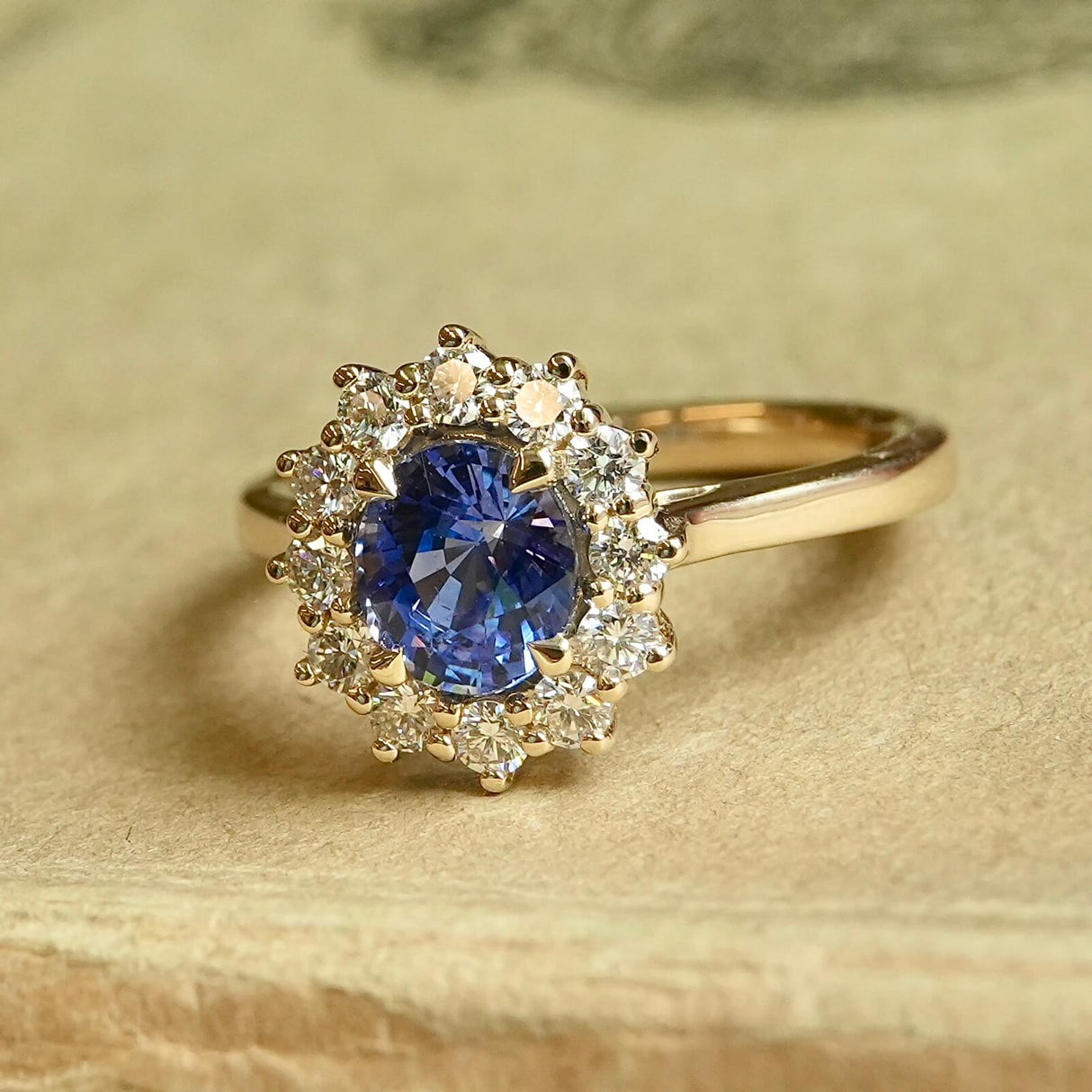 Oval-cut blue sapphire and diamond cluster engagement ring