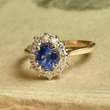 Oval-cut blue sapphire and diamond cluster engagement ring