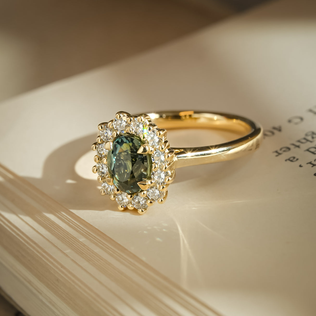 Oval green sapphire ring with diamond cluster halo setting