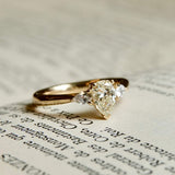 Pear cut diamond engagement ring with diamond side stones in yellow gold