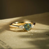 Pear green sapphire with diamond three stone engagement ring in yellow gold