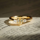 pear shaped yellow diamond three stone engagement ring with tapered side diamonds