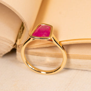 Elegant pink ruby solitaire ring with a striking pink gemstone and refined yellow gold band.