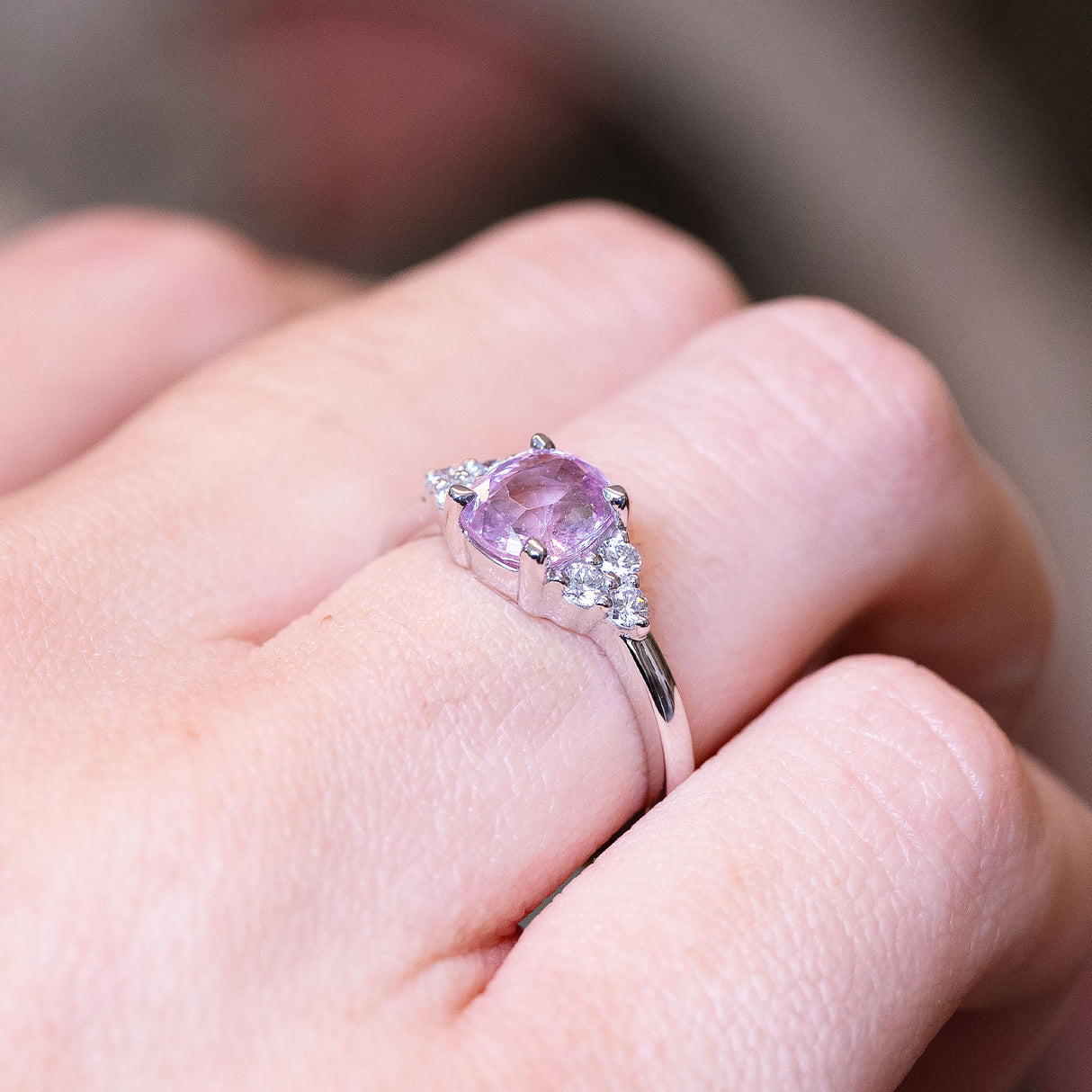 Pink sapphire and diamond cluster tre-foil engagement ring with soft pink sapphire centre stone and diamond clusters.