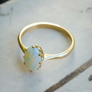 precious opal solitaire ring with vintage 1990s design in yellow gold