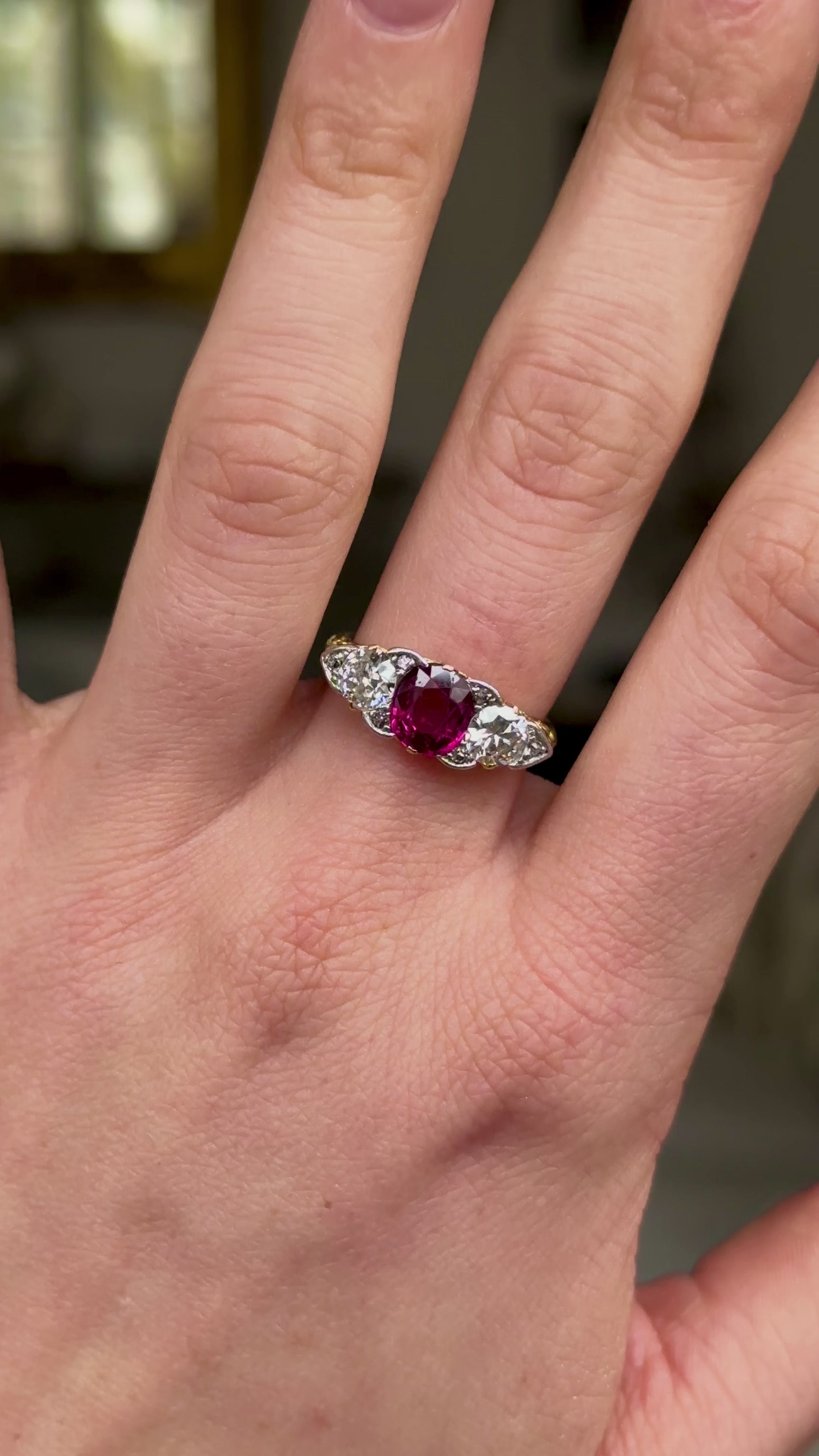 Antique, Edwardian Three Stone Ruby and Diamond Engagement Ring, worn on hand and rotated to give perspective.