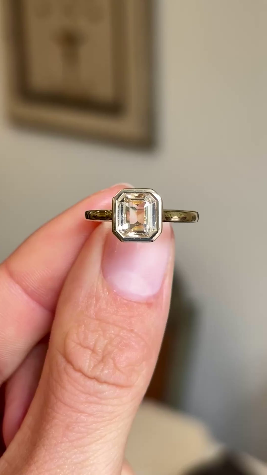 Close up video of an Antique-inspired yellow gold solitaire ring, set with a pale champagne yellow sapphire. 