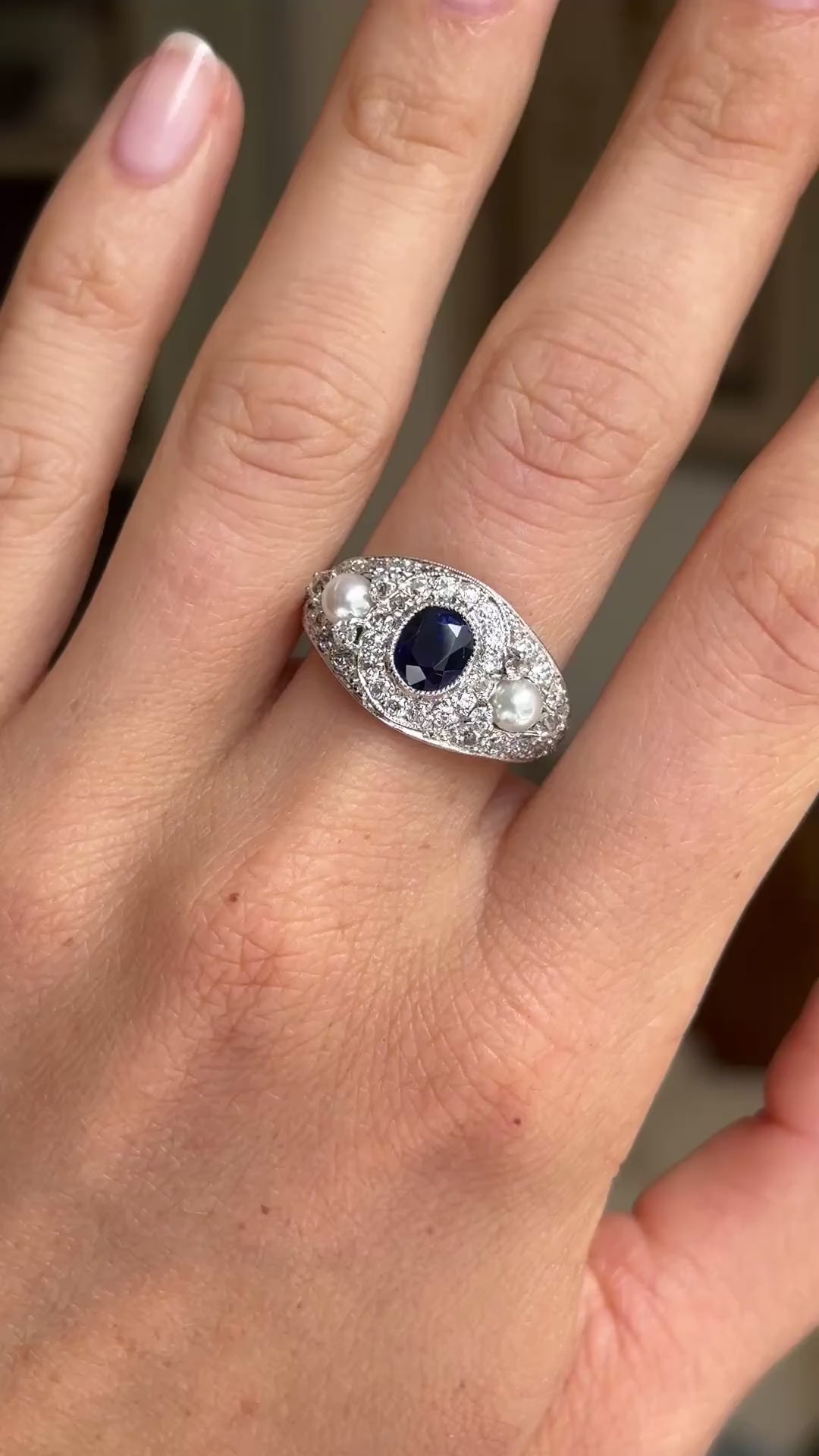 A video of a white gold Antique, Belle Époque blue sapphire, pearl and diamond cluster cocktail ring