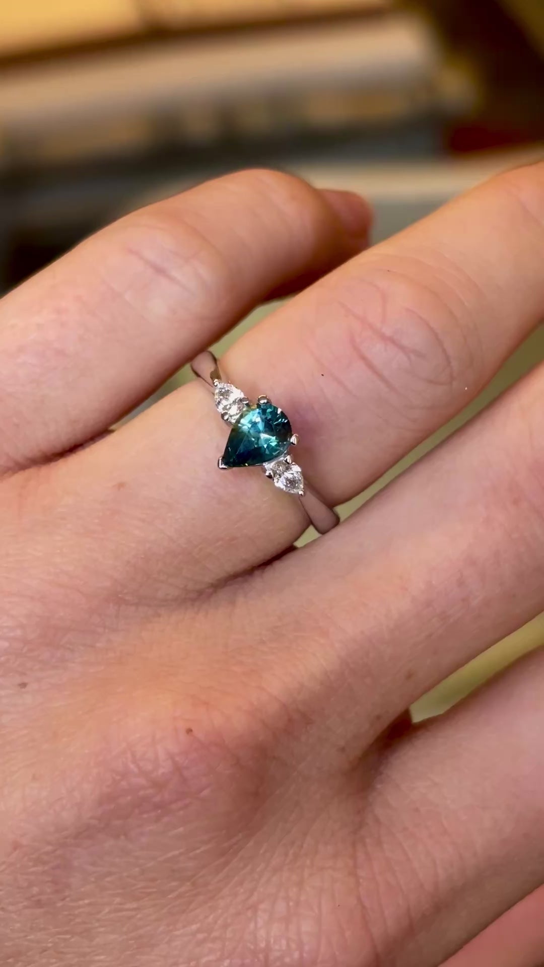 Pear-cut teal sapphire & diamond three-stone engagement ring