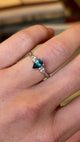 Pear-cut teal sapphire & diamond three-stone engagement ring