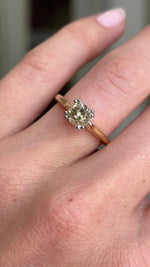 Vintage 1950s brown old-mine cut diamond solitaire engagement ring featuring a brown old-mine cut diamond in a classic solitaire setting, displayed on a hand.