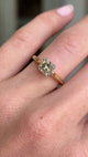 Vintage 1950s brown old-mine cut diamond solitaire engagement ring featuring a brown old-mine cut diamond in a classic solitaire setting, displayed on a hand.